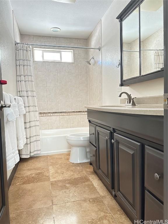 full bathroom featuring toilet, shower / tub combo, and vanity