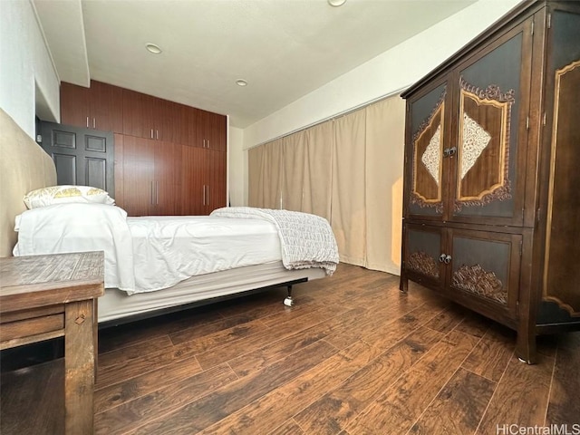 bedroom featuring dark hardwood / wood-style flooring