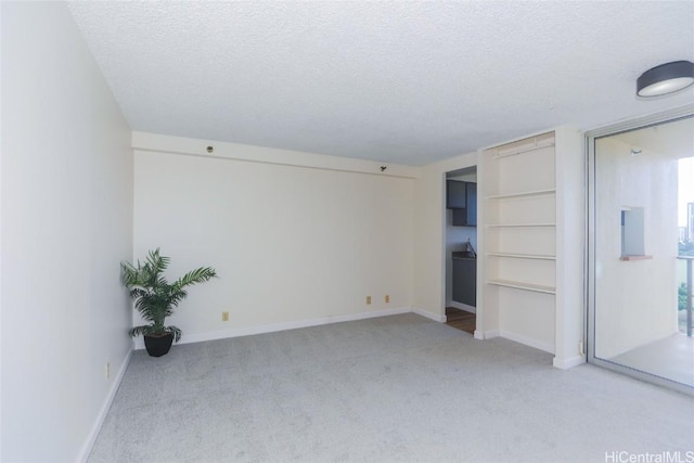 unfurnished bedroom with a textured ceiling and light carpet