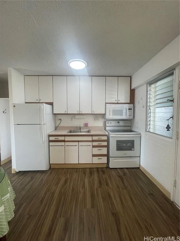 kitchen with white appliances, white cabinets, a textured ceiling, sink, and dark hardwood / wood-style floors