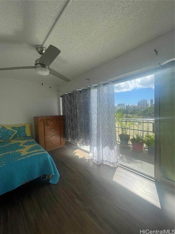 unfurnished bedroom featuring a textured ceiling, ceiling fan, and wood-type flooring