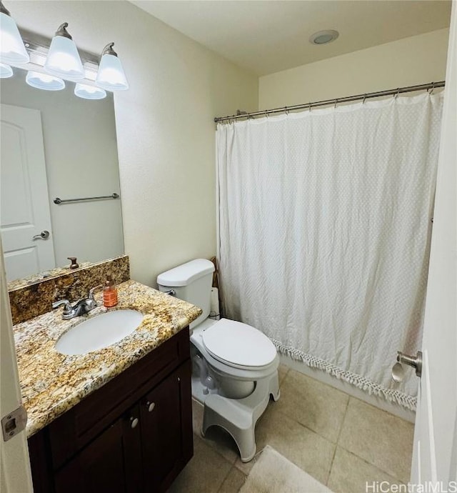 bathroom with tile patterned flooring, vanity, and toilet