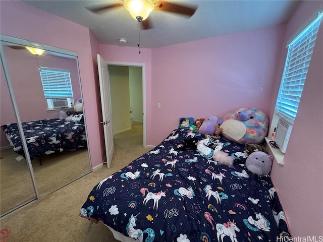 bedroom featuring multiple windows, carpet, ceiling fan, and a closet