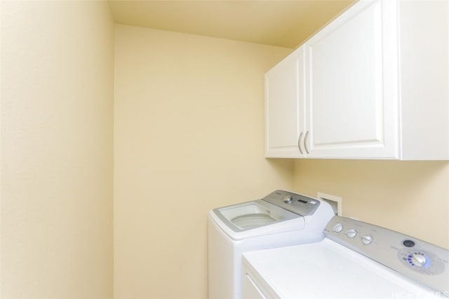 washroom featuring cabinets and washer and dryer