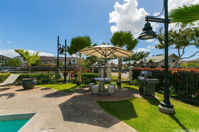 view of property's community with a yard and a patio area