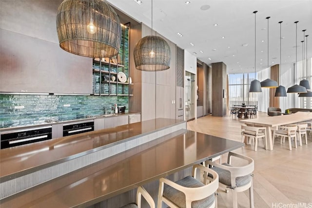 bar featuring decorative light fixtures, floor to ceiling windows, black oven, and backsplash