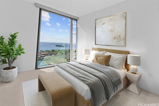 bedroom with floor to ceiling windows, carpet floors, and a water view