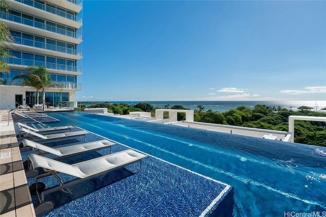 view of swimming pool featuring a water view