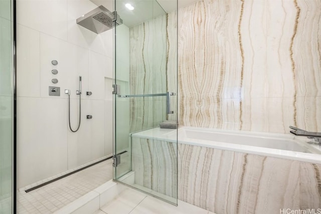 bathroom featuring tile walls, shower with separate bathtub, and tile patterned flooring