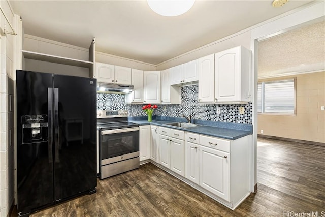 kitchen with white cabinetry, black fridge, sink, and electric range