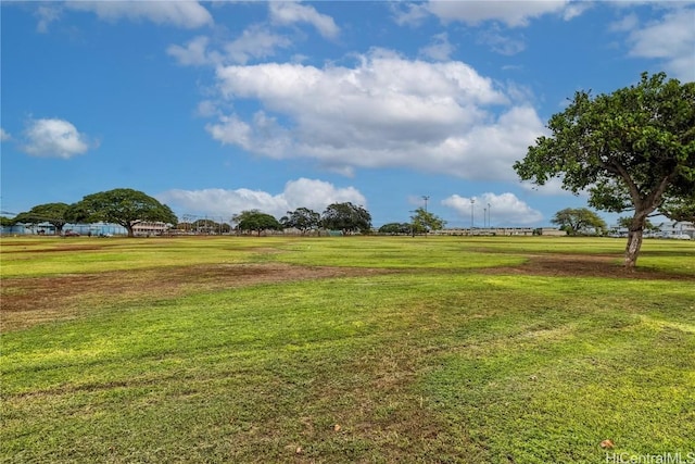 view of home's community with a rural view and a lawn