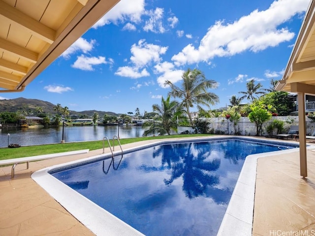 view of swimming pool with a water and mountain view and a patio area