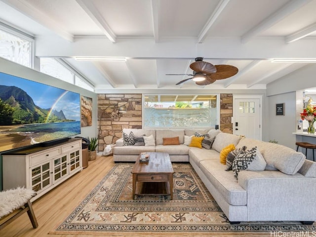 interior space featuring ceiling fan, hardwood / wood-style floors, and beam ceiling