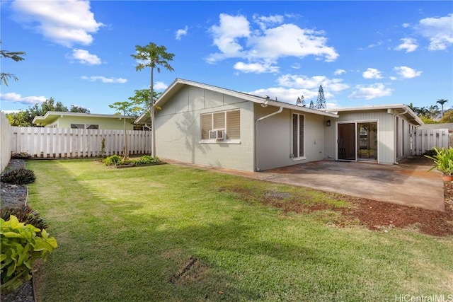 rear view of house featuring cooling unit, a yard, and a patio