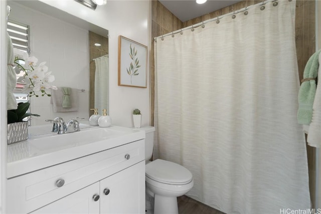 bathroom featuring toilet and vanity