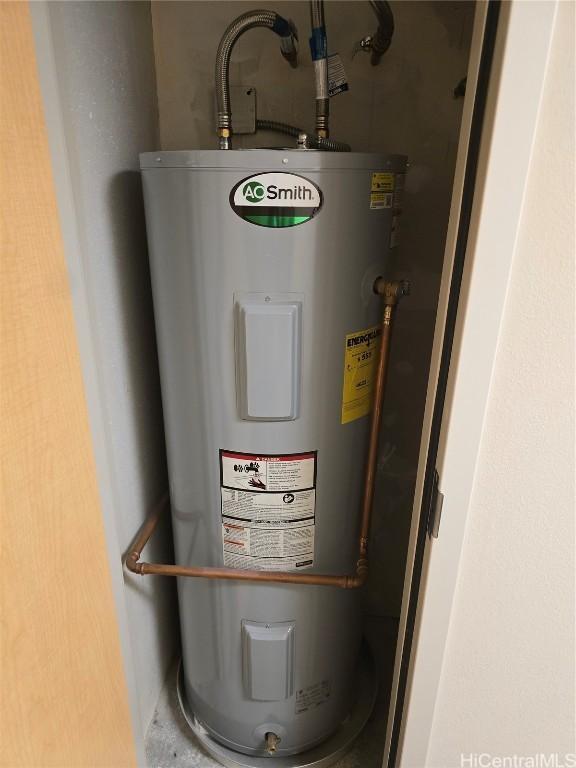 utility room featuring water heater