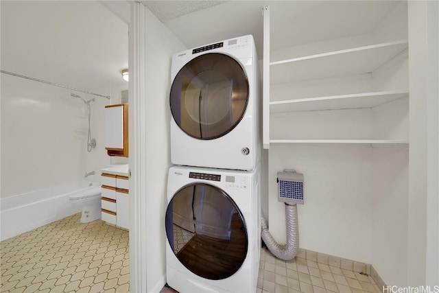 laundry room with stacked washer / dryer