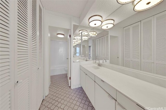 500 University Ave Unit 2406, Honolulu, HI 96826 - full bathroom with toilet, a textured ceiling, a closet, and vanity