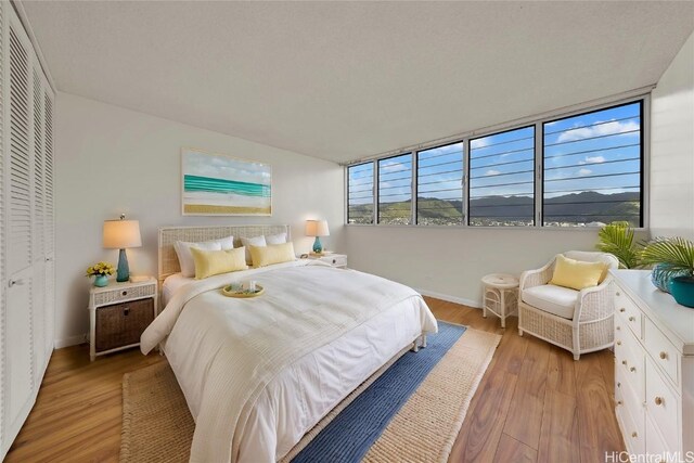 500 University Ave Unit 2406, Honolulu, HI 96826 - bedroom featuring light wood-style flooring and baseboards