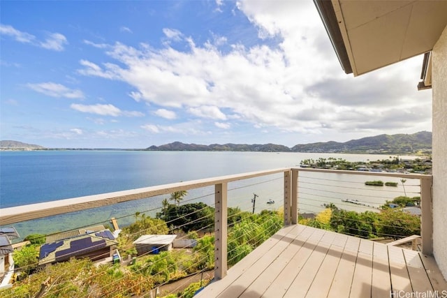 balcony featuring a water and mountain view