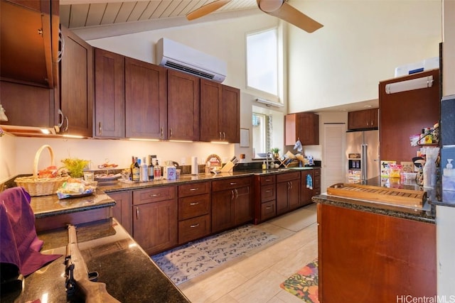 kitchen featuring high quality fridge, a wall mounted air conditioner, lofted ceiling with beams, sink, and ceiling fan