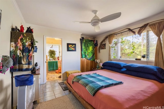 tiled bedroom with ornamental molding, ceiling fan, and ensuite bathroom