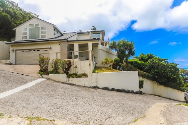 45-001 Lilipuna Rd Unit B, Kaneohe, HI 96744 - view of front of home with concrete driveway, stucco siding, and a garage