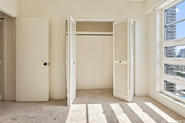 unfurnished bedroom with light carpet