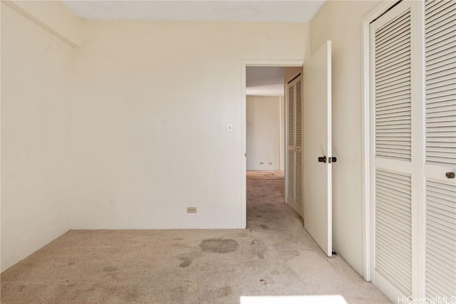 unfurnished bedroom featuring light carpet