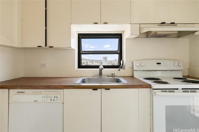 kitchen with white cabinets, butcher block countertops, sink, and white appliances