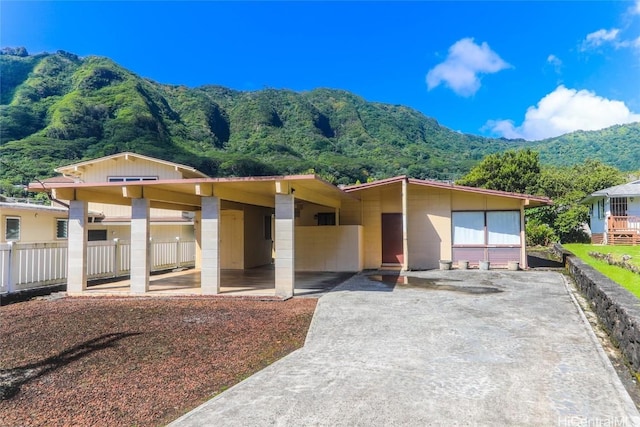 view of front of house featuring a mountain view and a carport