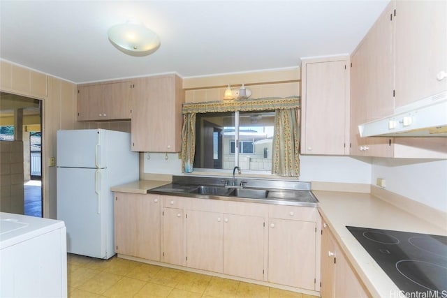 kitchen with sink, light brown cabinets, white refrigerator, and black electric cooktop