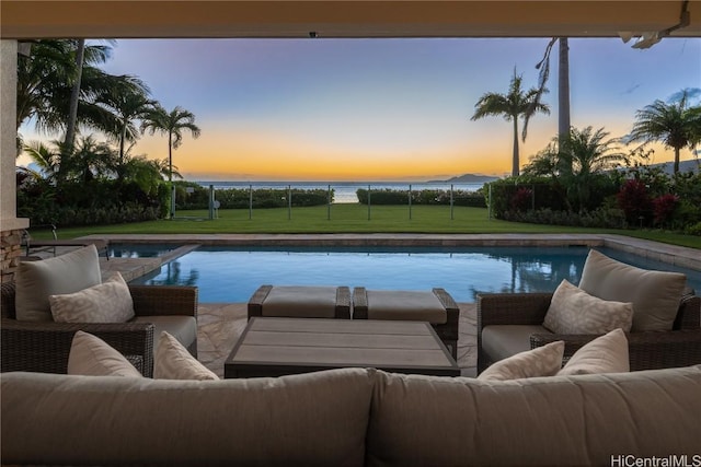 view of swimming pool featuring a pool with connected hot tub, fence, an outdoor hangout area, and a yard