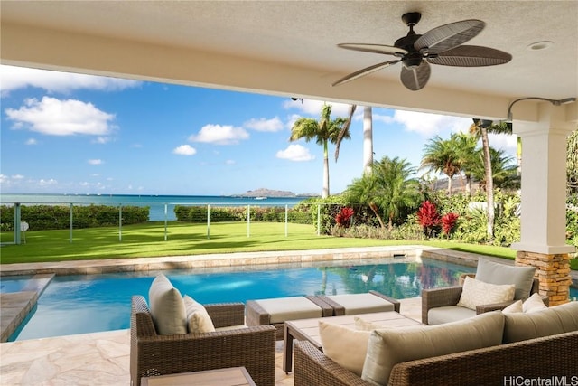 view of swimming pool featuring an outdoor living space, a water view, a ceiling fan, and a patio area