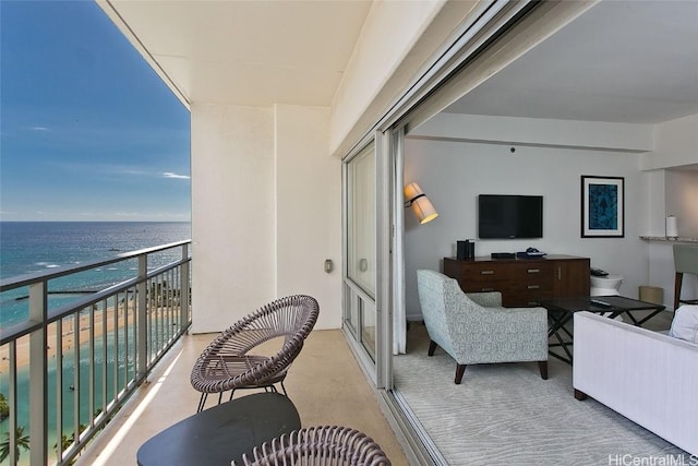 balcony with a water view and a beach view