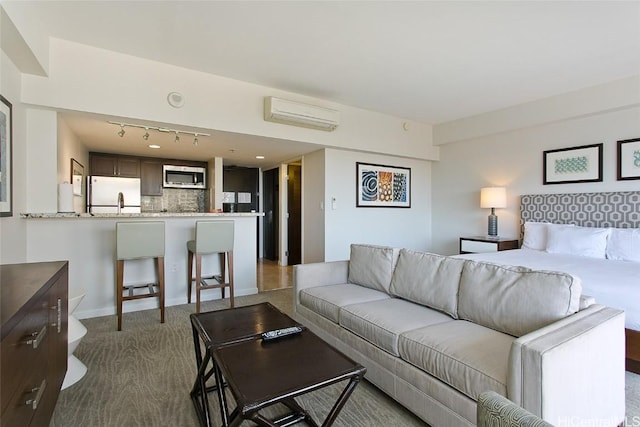 carpeted living room with a wall mounted AC