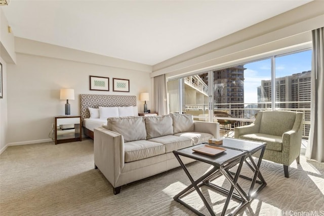 bedroom with baseboards, a view of city, and light colored carpet