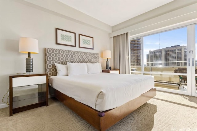 carpeted bedroom featuring baseboards and a city view