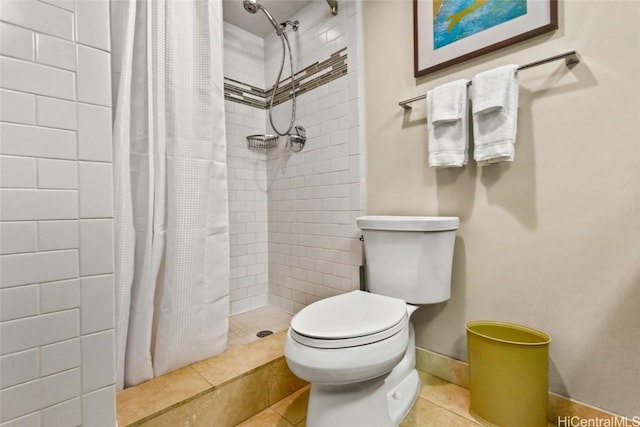 full bath featuring baseboards, a shower stall, toilet, and tile patterned floors