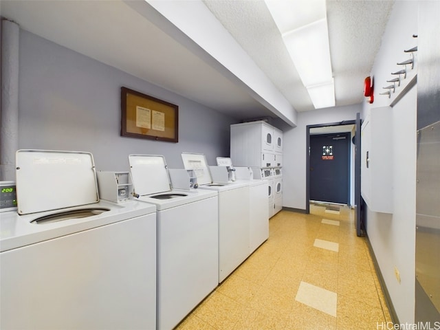 washroom with stacked washer and clothes dryer and separate washer and dryer