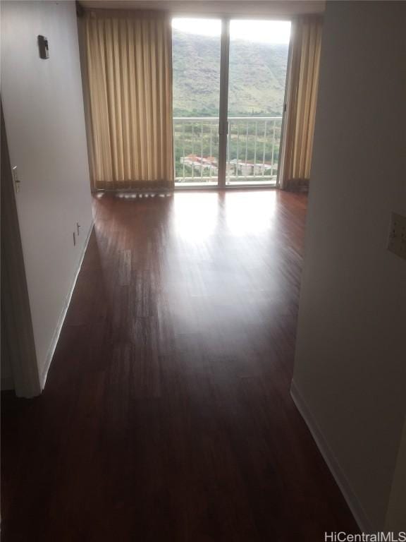 unfurnished room featuring dark hardwood / wood-style flooring