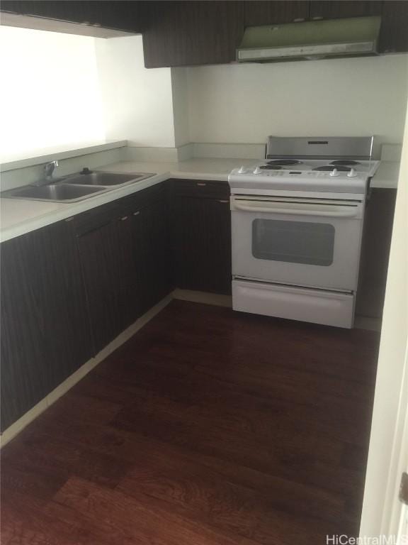 kitchen with sink, white range oven, and dark wood-type flooring