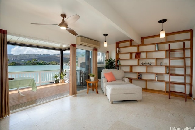 living area with a wall unit AC, a water and mountain view, beam ceiling, and ceiling fan