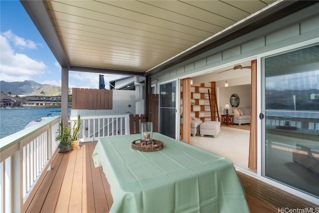 deck with a water and mountain view