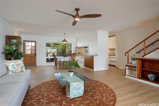 living room featuring light hardwood / wood-style floors and ceiling fan