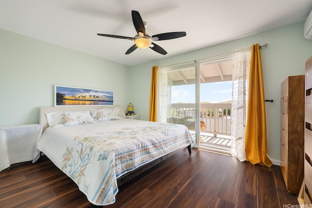 bedroom featuring access to outside, a wall mounted air conditioner, dark wood finished floors, and a ceiling fan