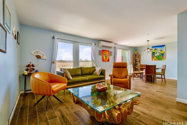 living area with a wall mounted AC, wood finished floors, and baseboards