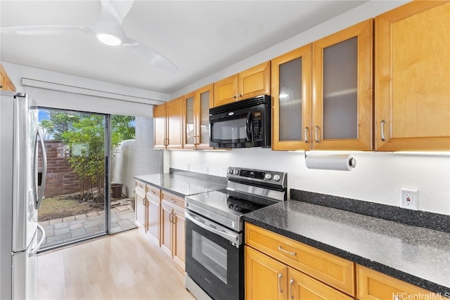 kitchen with light hardwood / wood-style floors and appliances with stainless steel finishes