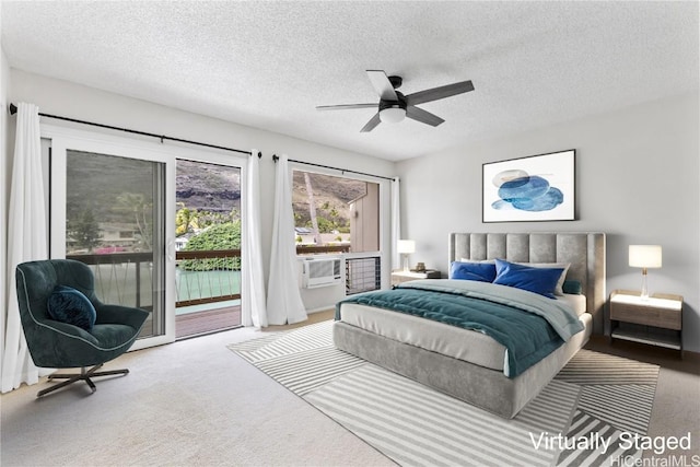 bedroom with ceiling fan, access to outside, carpet, and a textured ceiling