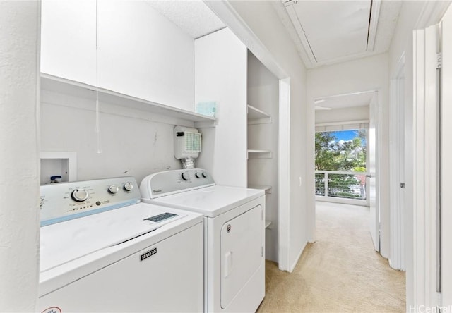 laundry area with washer and dryer and light carpet